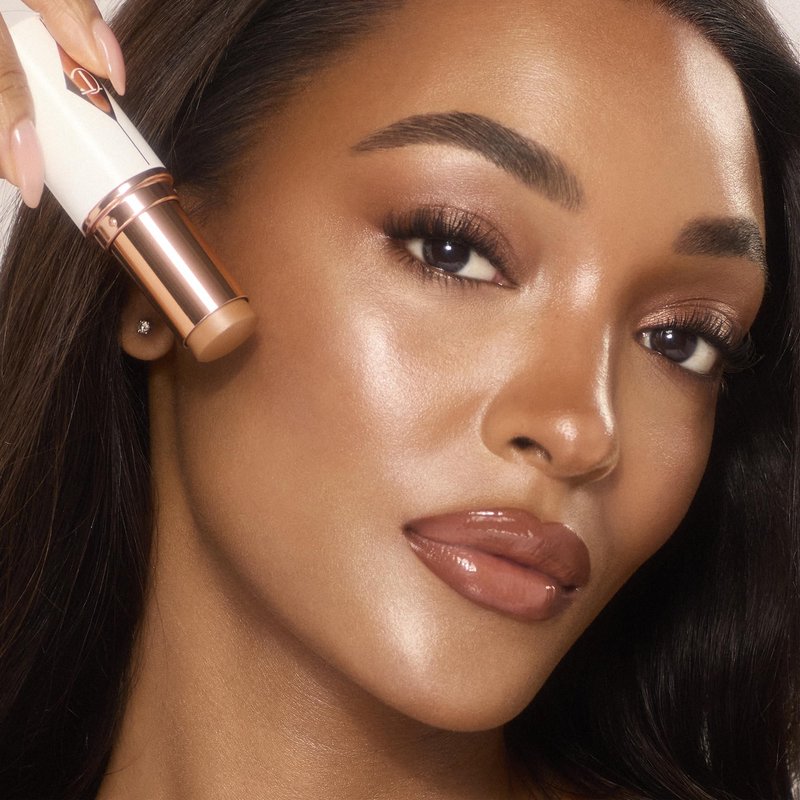 Charlotte Tilbury Unreal Skin Tint & Sheer Glow Hydrating Foundation Stick - Cream Foundation Makeup with Sheer-to-Light Coverage & a Buildable Formula - Blurring, Smoothing & Nourishing - 10 Tan
